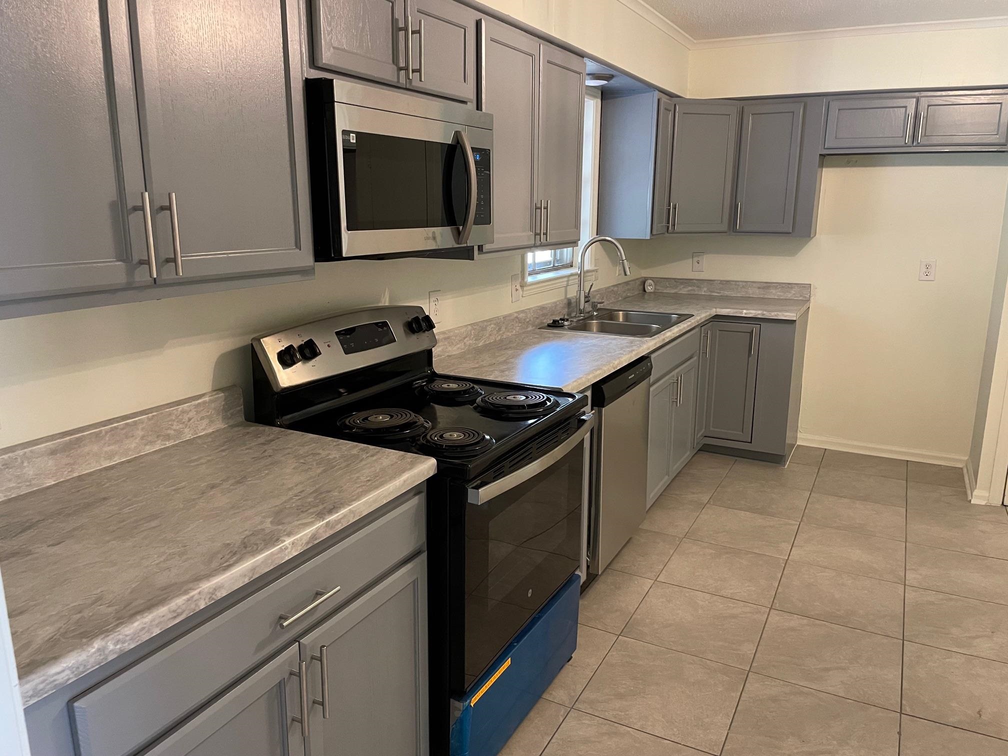 1898 Pennel Road Memphis, TN 38116 - Photo 6 of 34 a kitchen that has a sink and a stove in it
