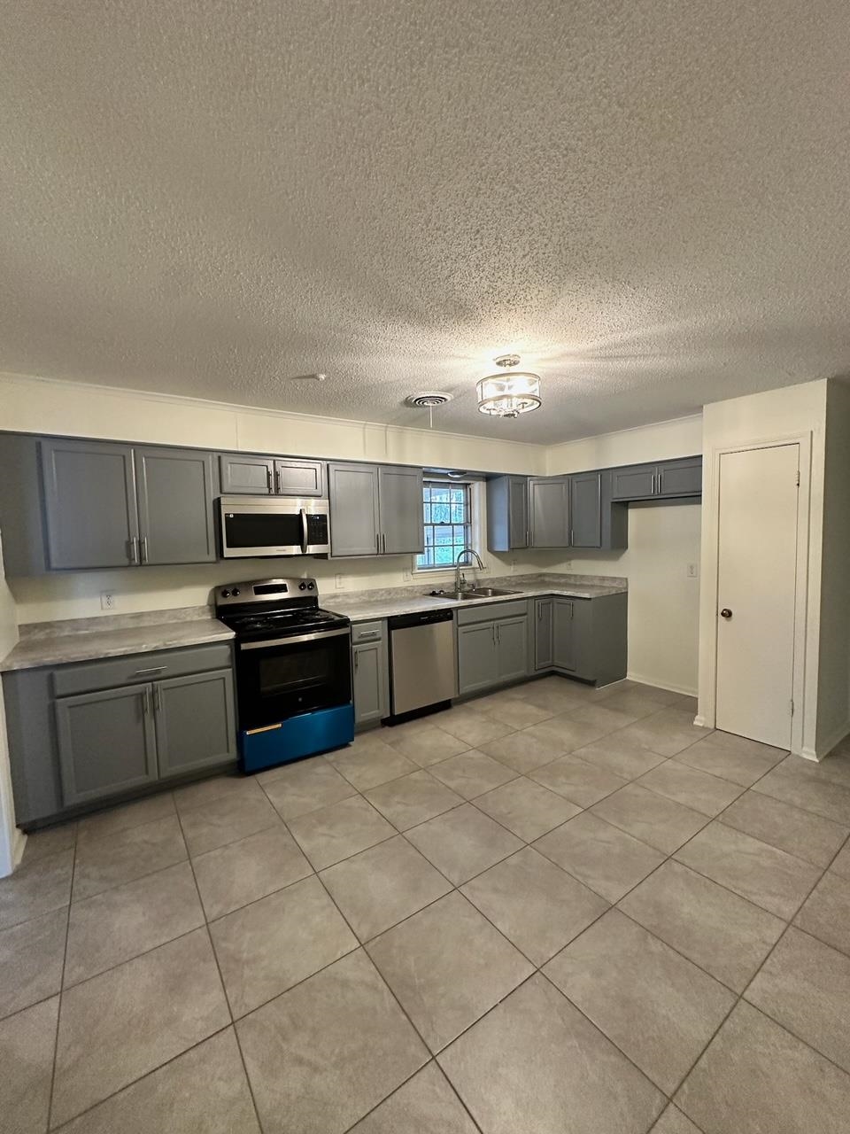 1898 Pennel Road Memphis, TN 38116 - Photo 7 of 34 a open kitchen with cabinets and stainless steel appliances