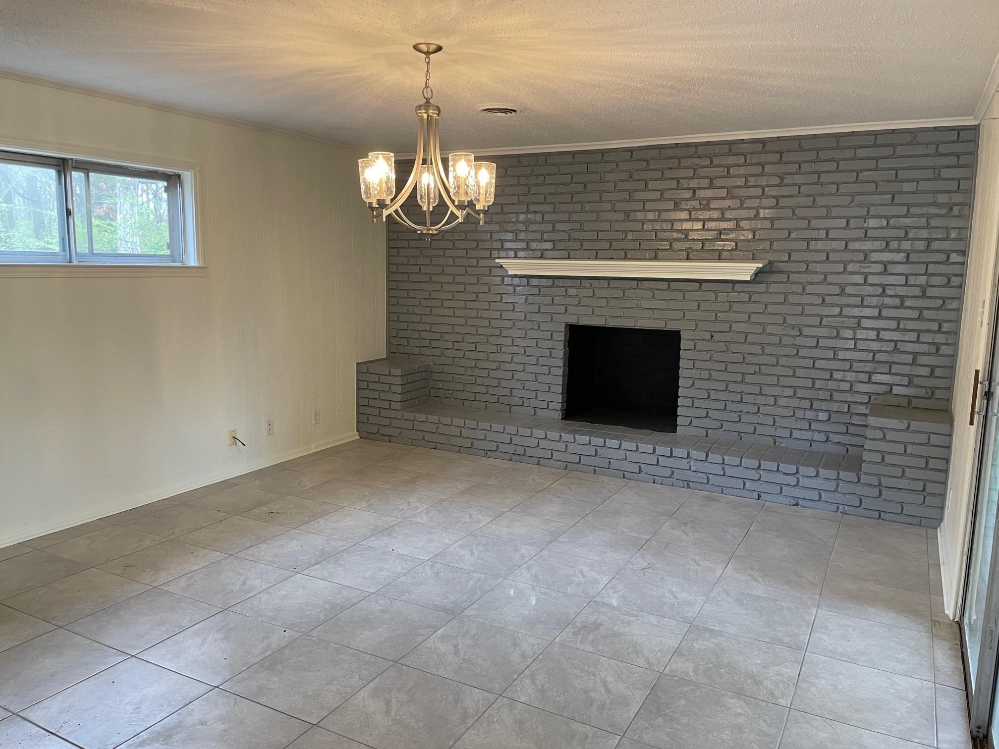 1898 Pennel Road Memphis, TN 38116 - Photo 10 of 34 a view of a livingroom with a chandelier fireplace and large window