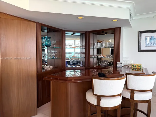 a large kitchen with stainless steel appliances kitchen island granite countertop a sink and cabinets