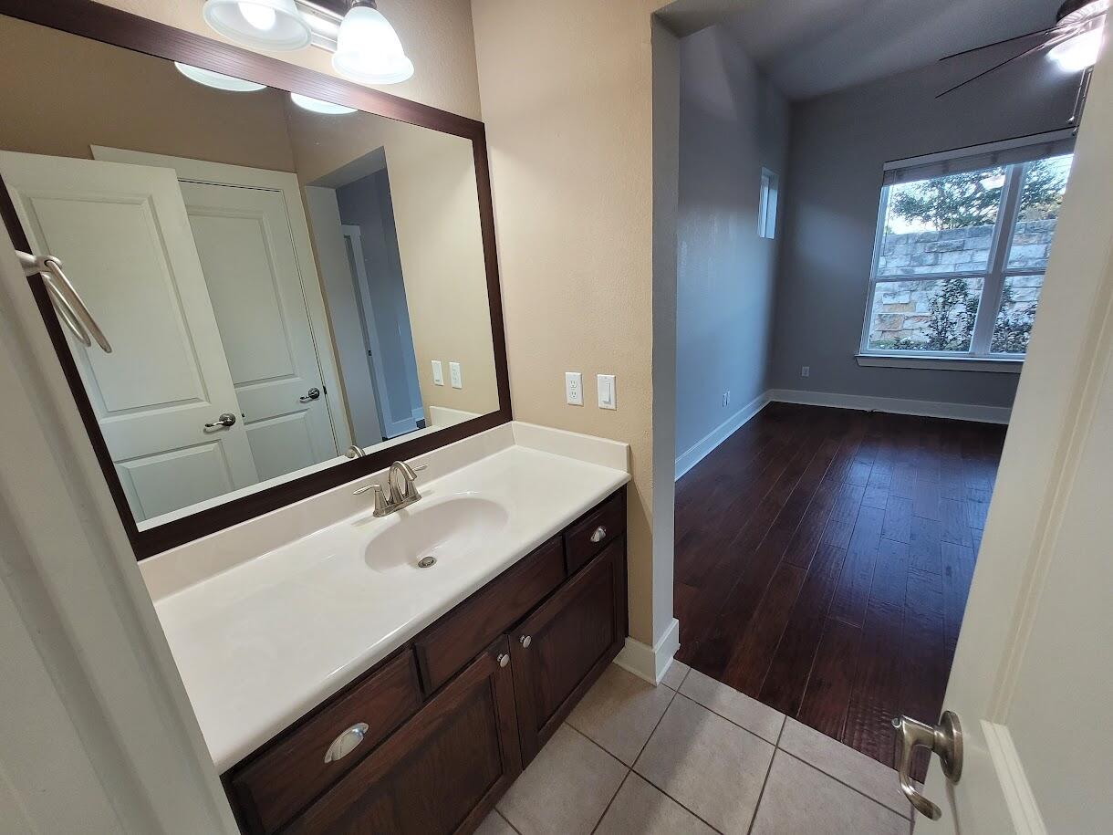 2404 Vintage Stave Road, Unit 102 Austin, TX 78748 - Photo 16 of 39 a room with a sink a mirror and a window