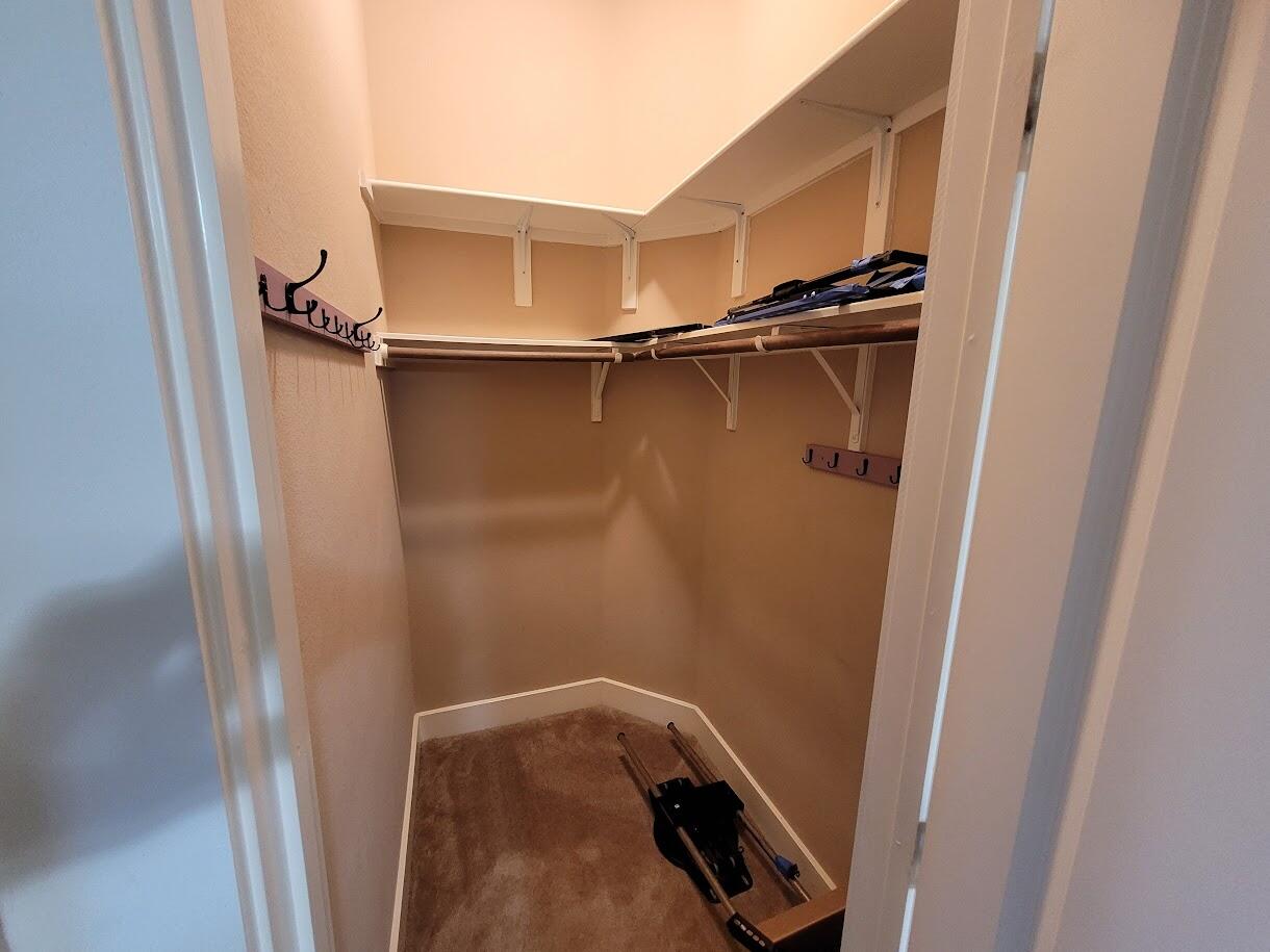 2404 Vintage Stave Road, Unit 102 Austin, TX 78748 - Photo 17 of 39 a view of walk in closet with clothes and shoes