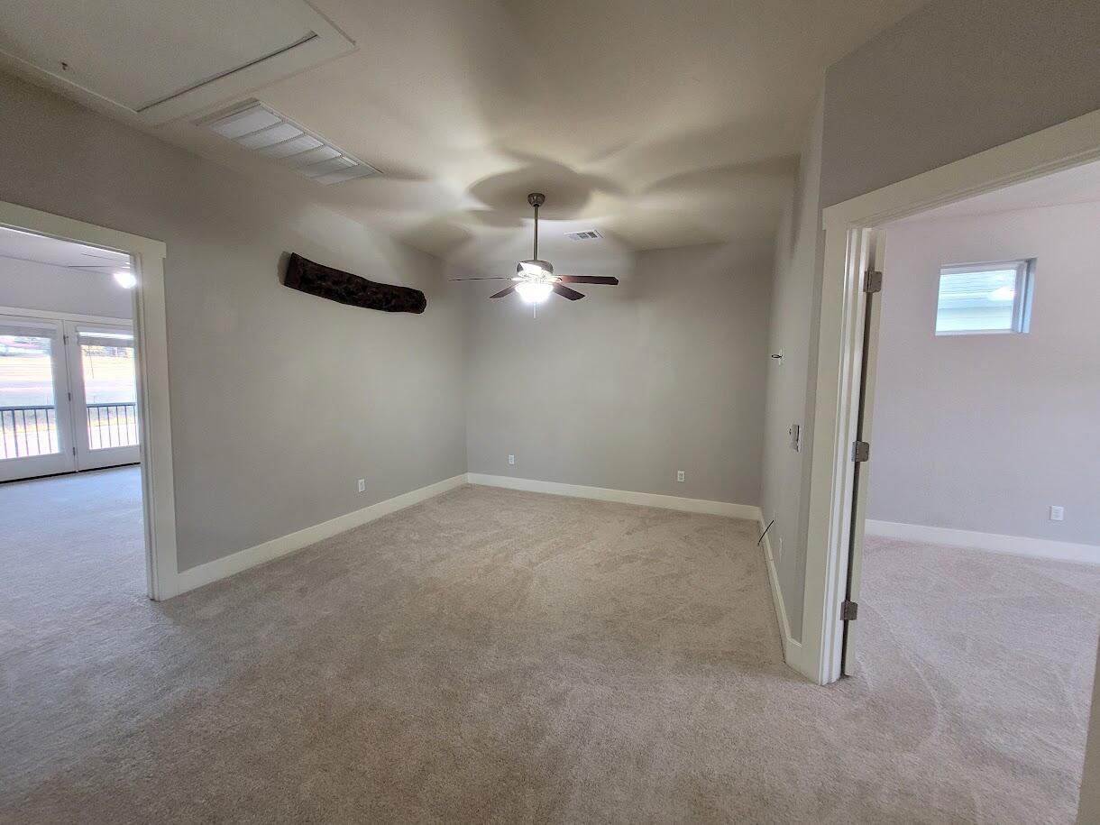 2404 Vintage Stave Road, Unit 102 Austin, TX 78748 - Photo 19 of 39 en empty room with windows and ceiling fan