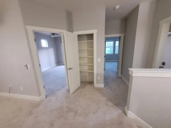 an empty room with closet and mirror