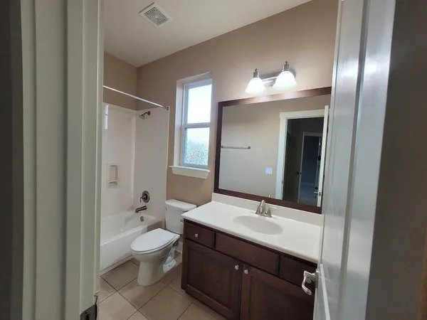 a bathroom with a sink a toilet a shower and mirror