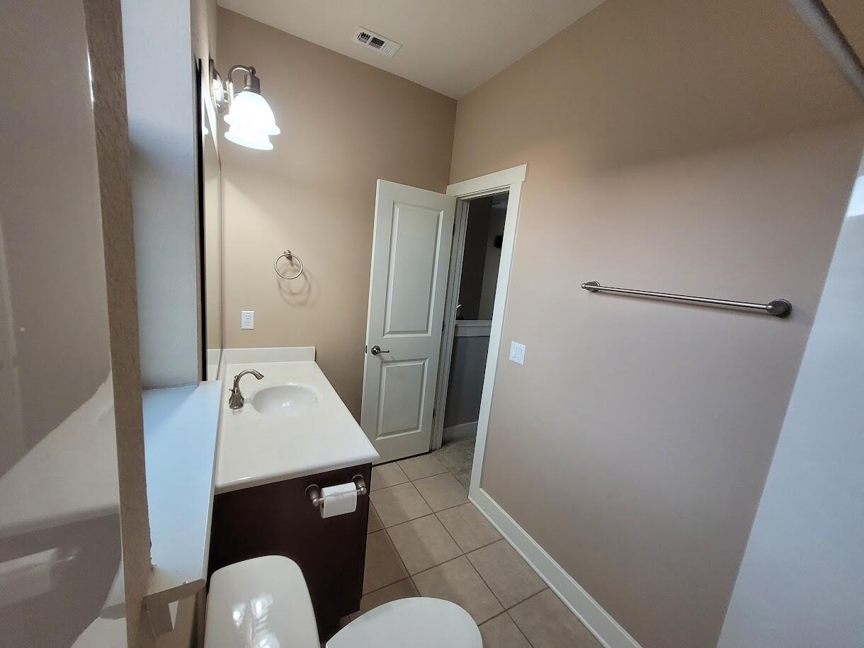 2404 Vintage Stave Road, Unit 102 Austin, TX 78748 - Photo 30 of 39 a bathroom with a sink a toilet a shower and mirror