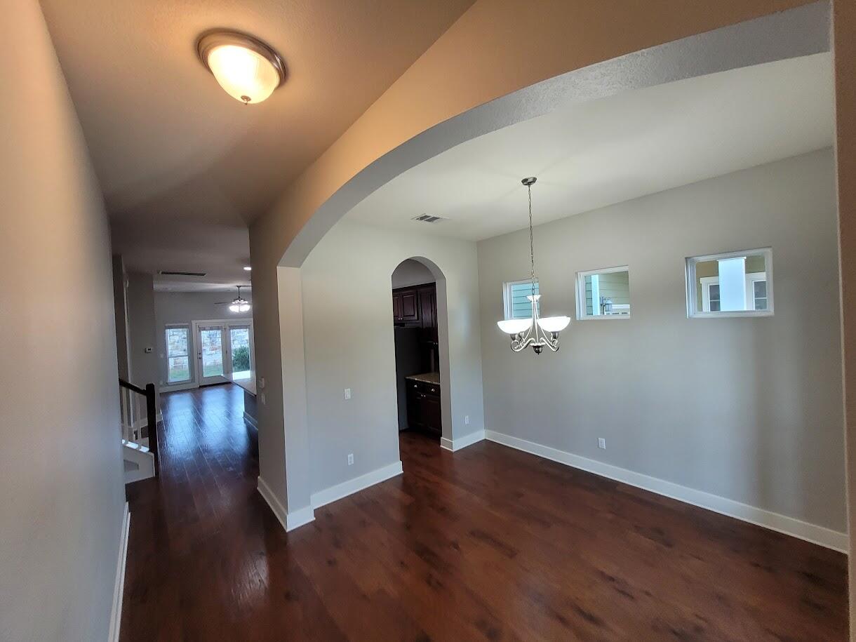 2404 Vintage Stave Road, Unit 102 Austin, TX 78748 - Photo 3 of 39 wooden floor in an empty room with a window