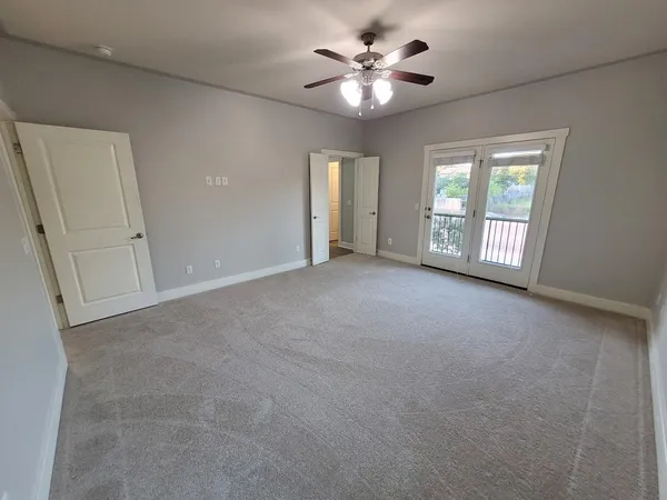 a view of a livingroom with a ceiling fan a flat screen tv and a ceiling fan