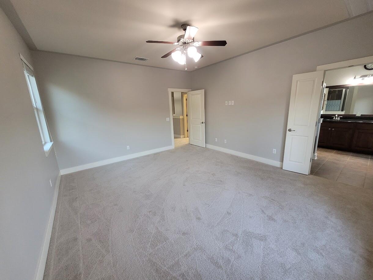 2404 Vintage Stave Road, Unit 102 Austin, TX 78748 - Photo 32 of 39 a view of a livingroom with a ceiling fan a flat screen tv and a ceiling fan