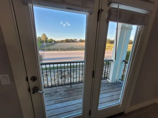 a view of balcony with wooden floor and city view