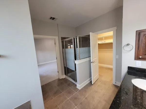 a bathroom with double vanity sink and a mirror