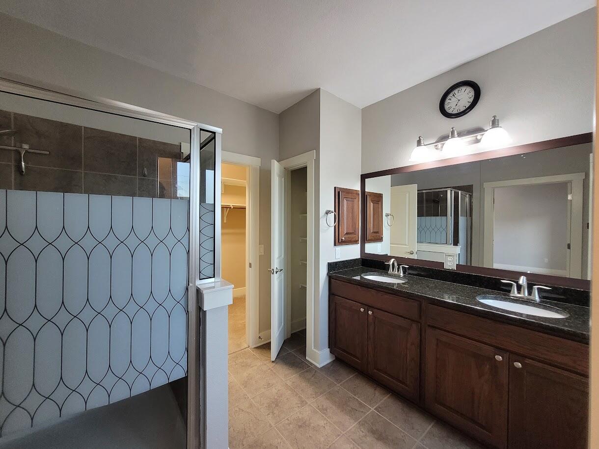 2404 Vintage Stave Road, Unit 102 Austin, TX 78748 - Photo 37 of 39 a bathroom with double vanity sink and a mirror