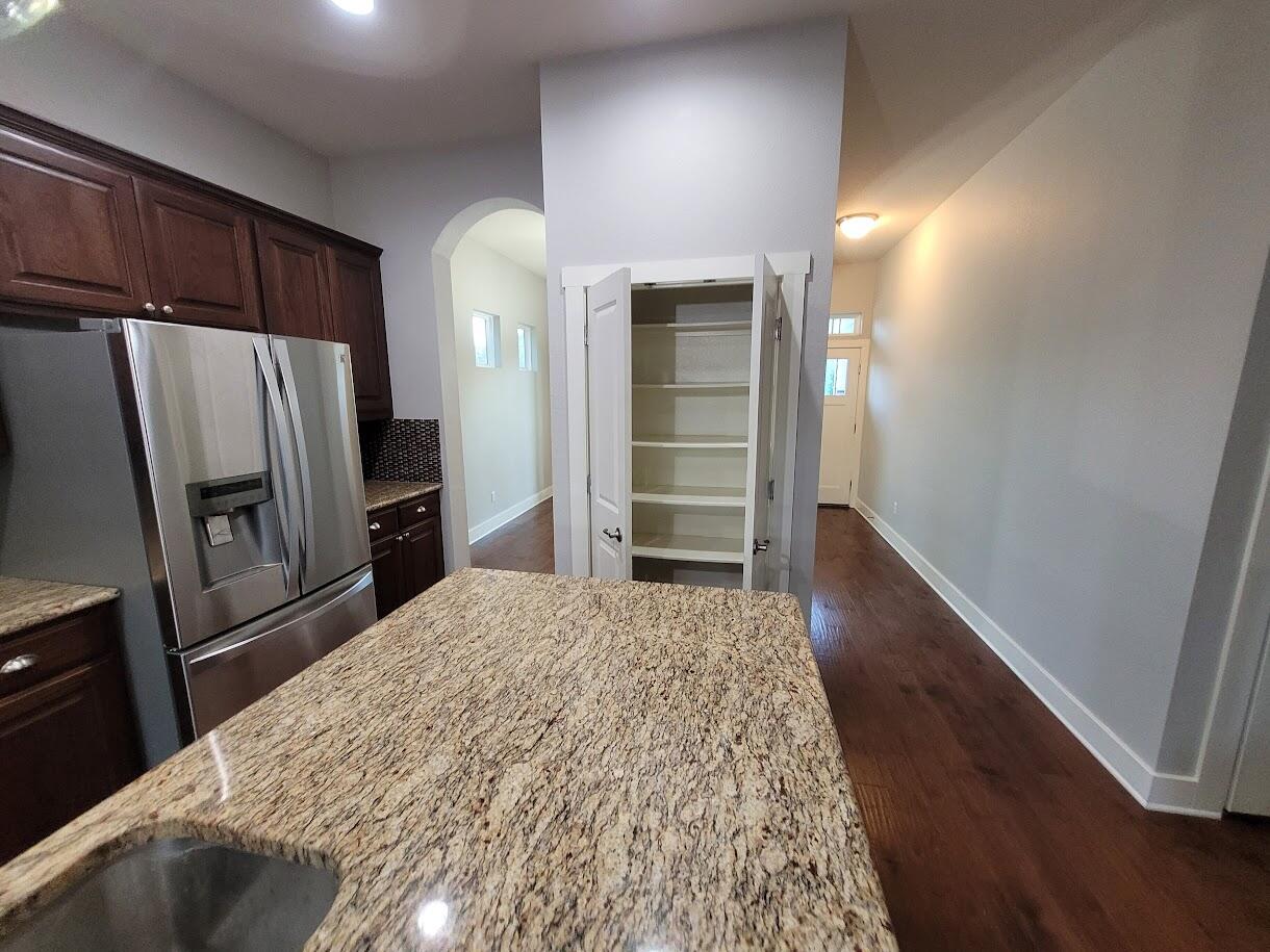 2404 Vintage Stave Road, Unit 102 Austin, TX 78748 - Photo 8 of 39 a kitchen with granite countertop a refrigerator and a sink