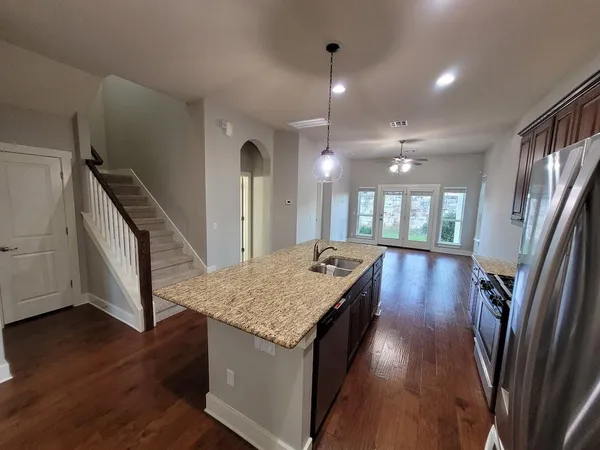 a kitchen with sink cabinets and wooden floor