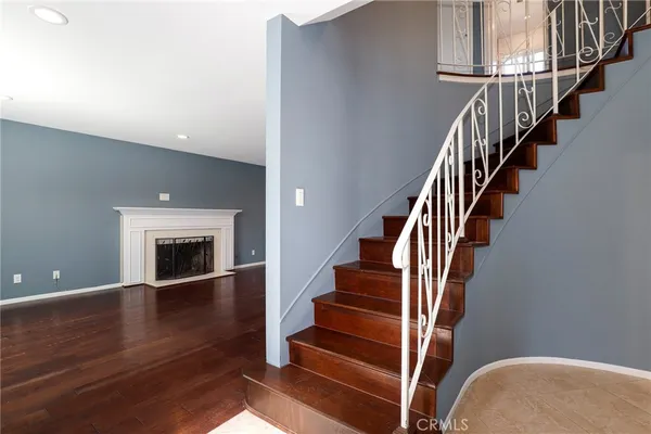 a view of entryway and hall with wooden floor