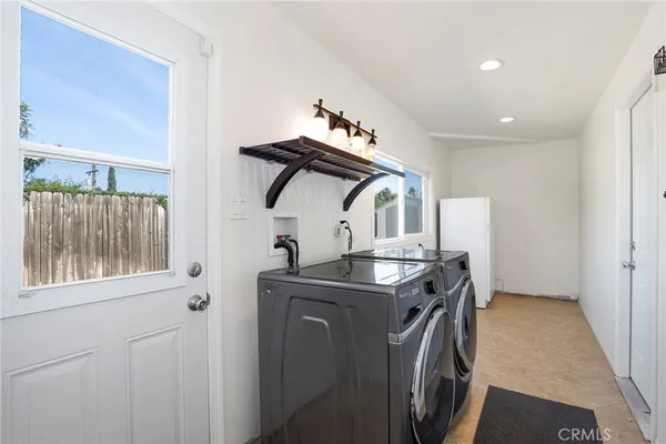 a view of a hallway with washer and dryer
