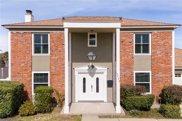 a front view of a house with white walls