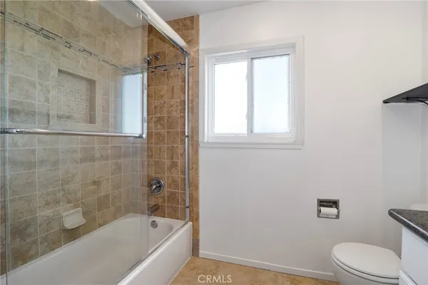 a bathroom with a bathtub toilet and shower
