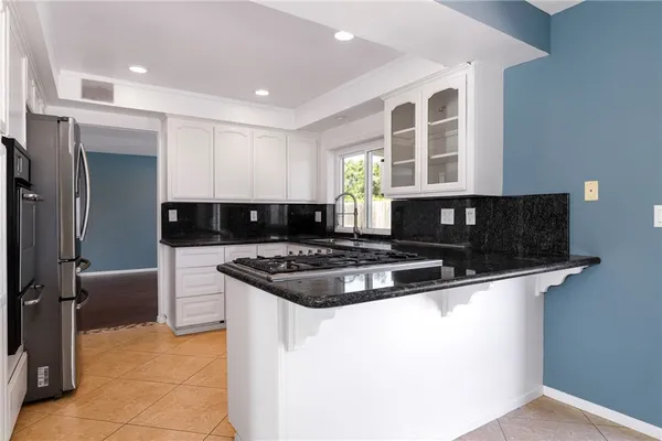 a kitchen with granite countertop a stove and a sink