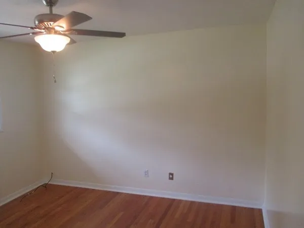 a view of a room with wooden floor