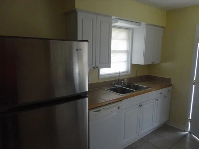 a kitchen with a sink and a refrigerator