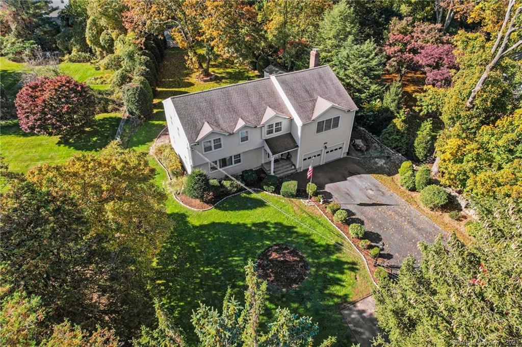 an aerial view of a house with a yard basket ball court and outdoor seating