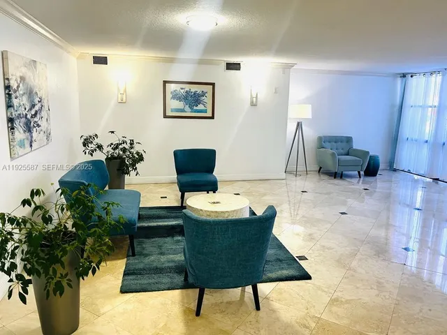 a living room with furniture and flowers