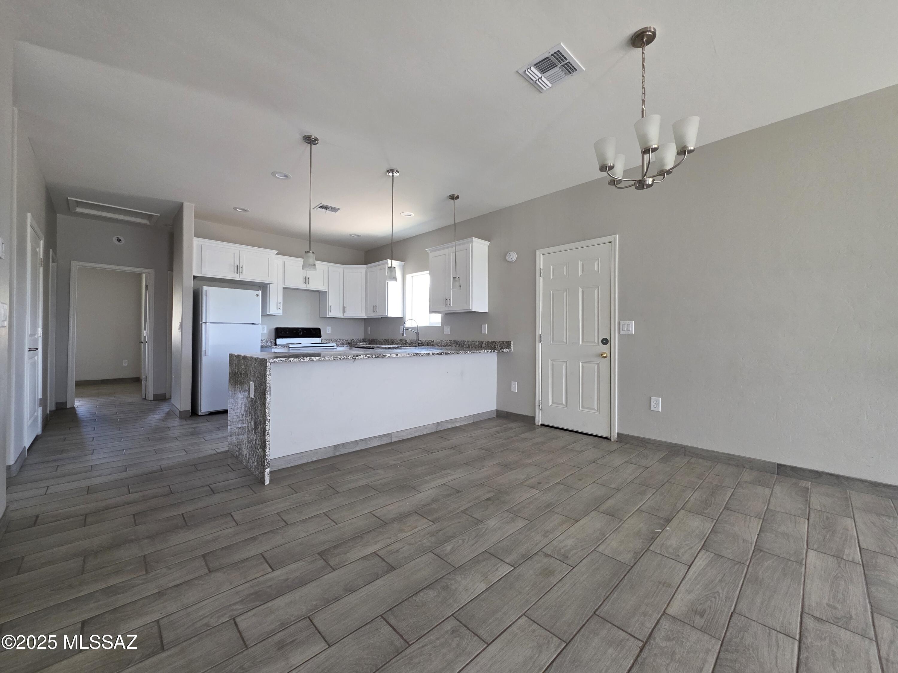 120 Via Venezuela Rio Rico, AZ 85648 - Photo 2 of 37 a view of a kitchen with a sink cabinets and wooden floor