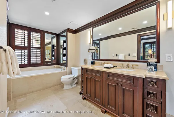 a bath tub sitting in front of a bathroom next to a window