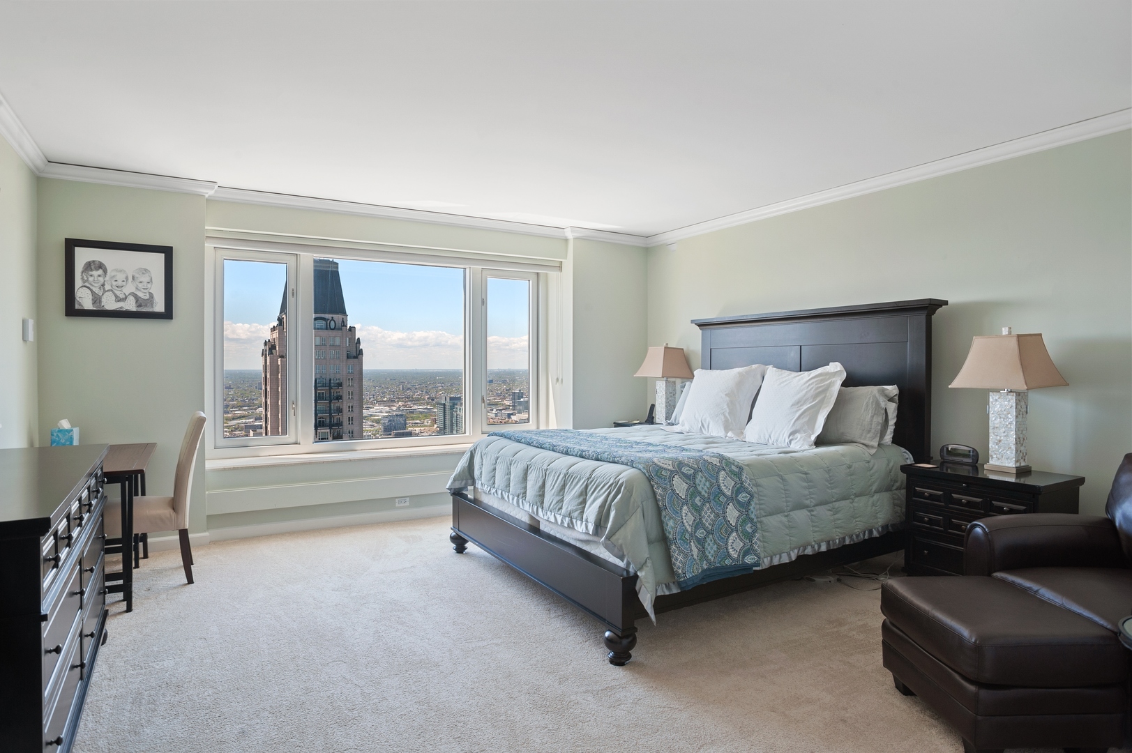 132 East Delaware Place, Unit 4801 Chicago, IL 60611 - Photo 16 of 20 a spacious bedroom with a bed and a large window