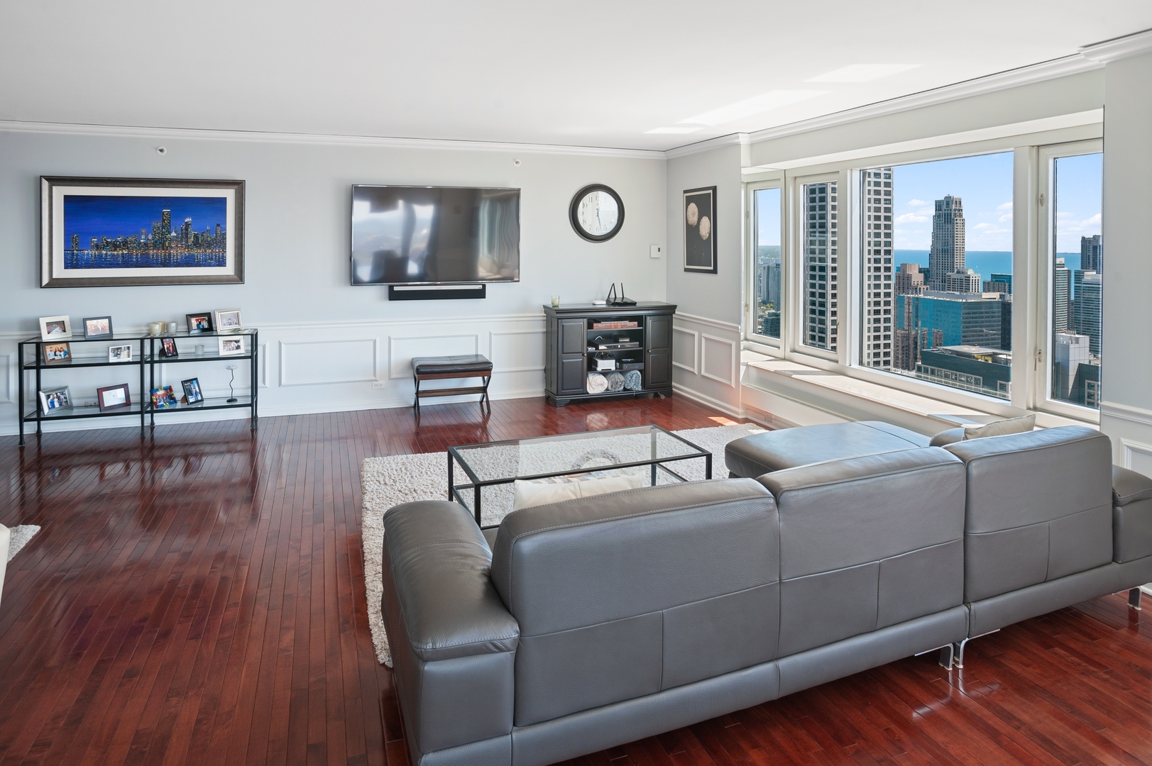 132 East Delaware Place, Unit 4801 Chicago, IL 60611 - Photo 5 of 20 a living room with furniture and wooden floor
