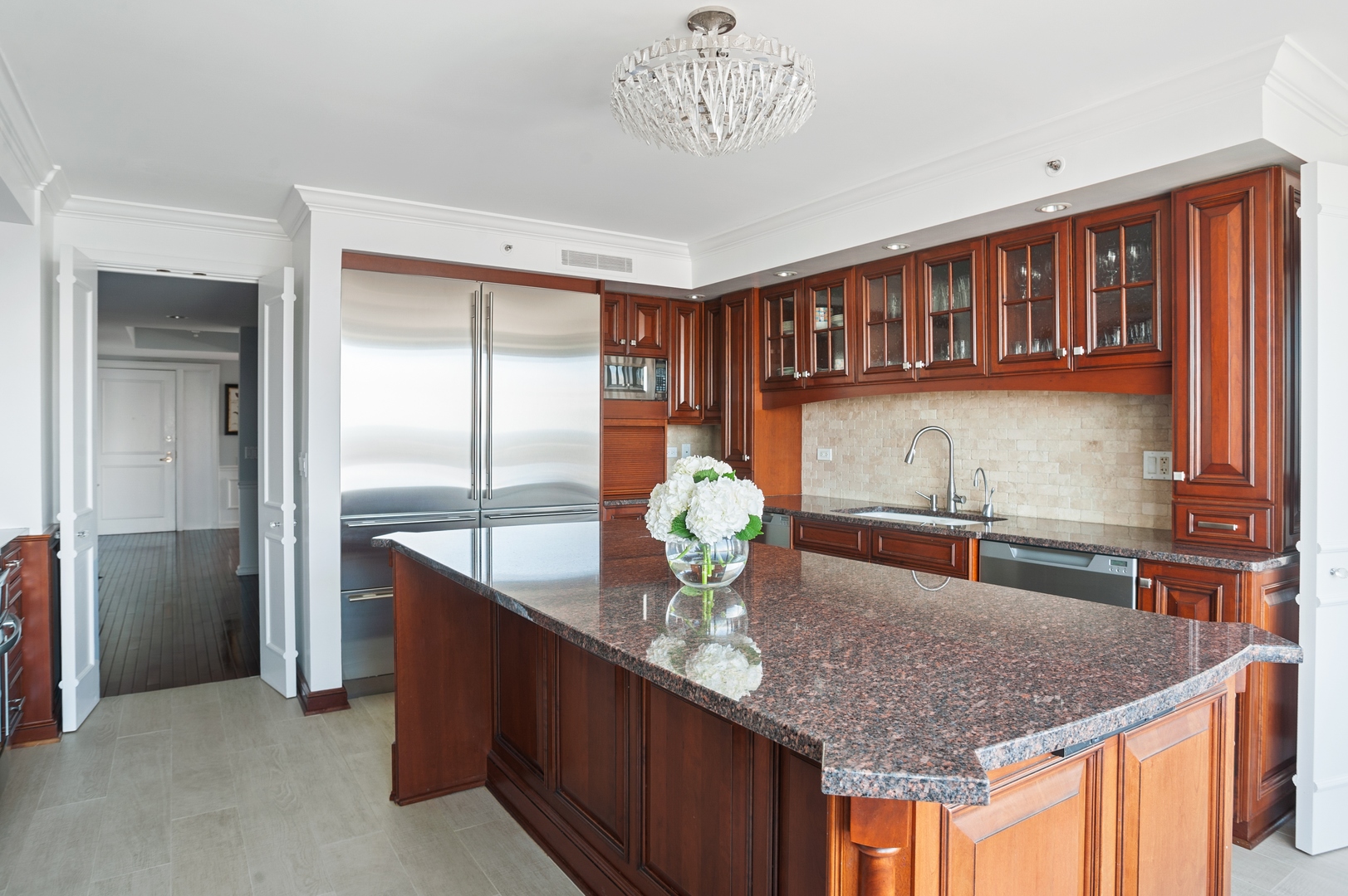 132 East Delaware Place, Unit 4801 Chicago, IL 60611 - Photo 10 of 20 a kitchen with stainless steel appliances granite countertop a sink and a refrigerator