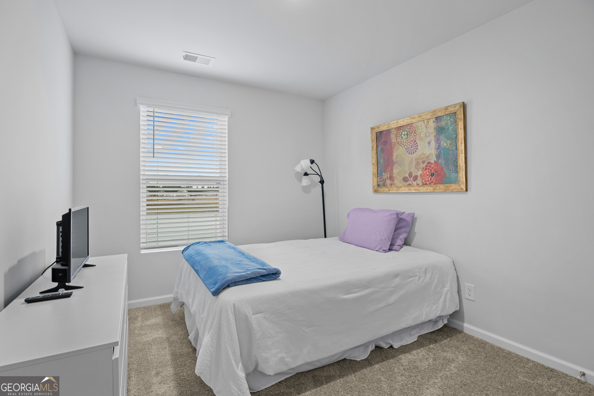 184 Coneflower Road Bloomingdale, GA 31302 - Photo 15 of 22 a bedroom with a bed and a flat screen tv
