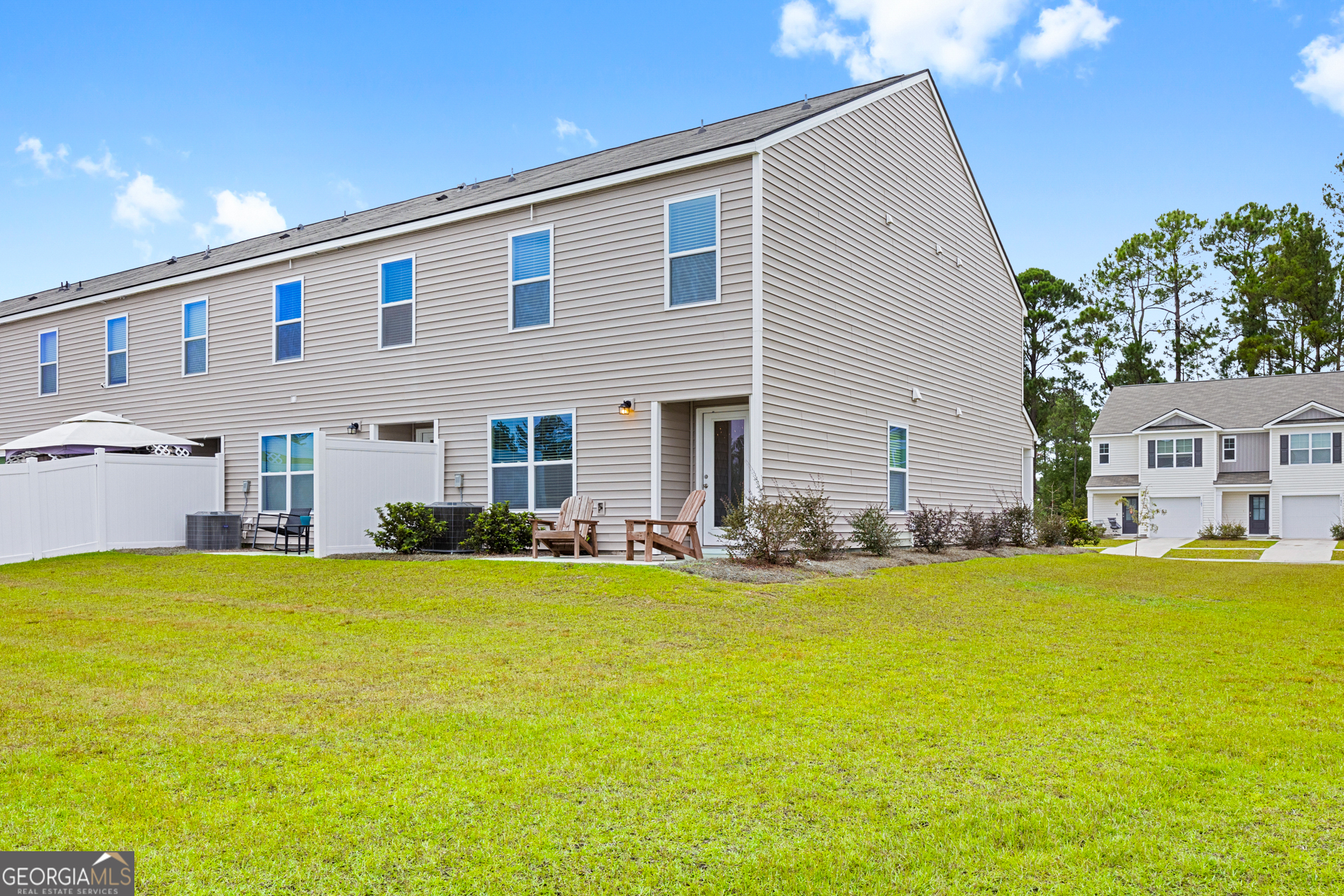 184 Coneflower Road Bloomingdale, GA 31302 - Photo 18 of 22 a view of a house with swimming pool and a yard