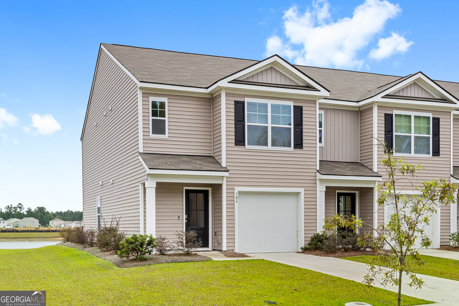 184 Coneflower Road Bloomingdale, GA 31302 - Photo 2 of 22 a front view of a house with garden