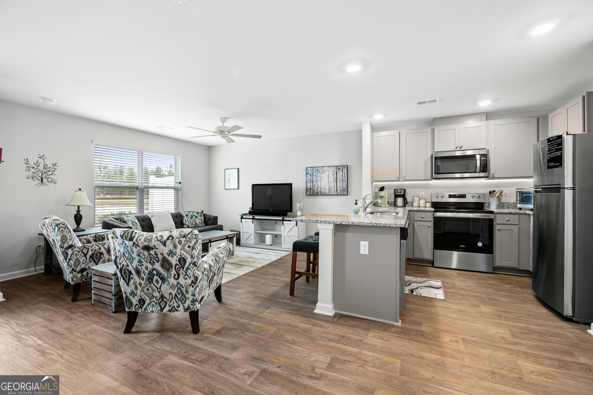 184 Coneflower Road Bloomingdale, GA 31302 - Photo 4 of 22 a living room with furniture a flat screen tv and kitchen view