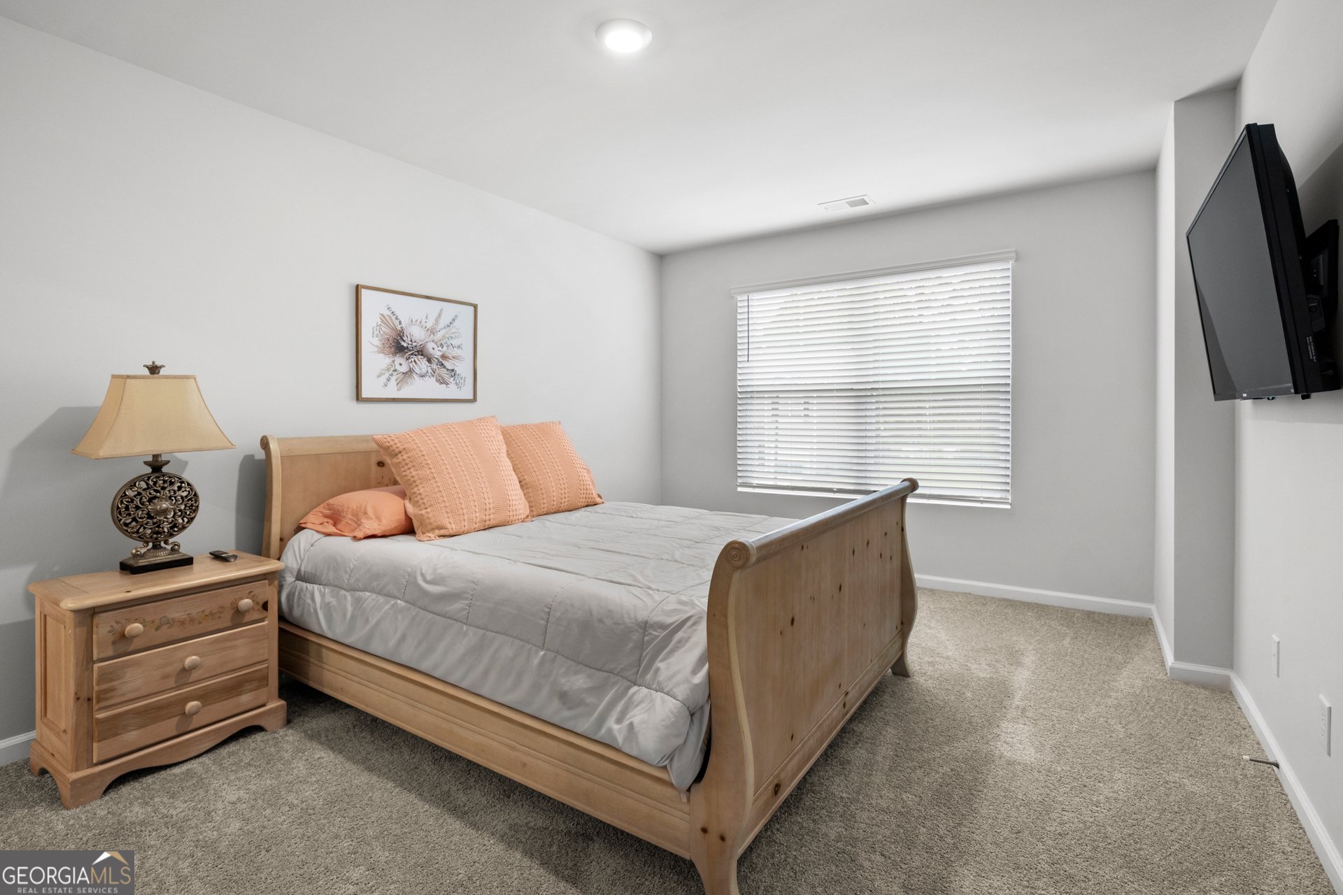 184 Coneflower Road Bloomingdale, GA 31302 - Photo 8 of 22 a bedroom with a bed and a flat screen tv