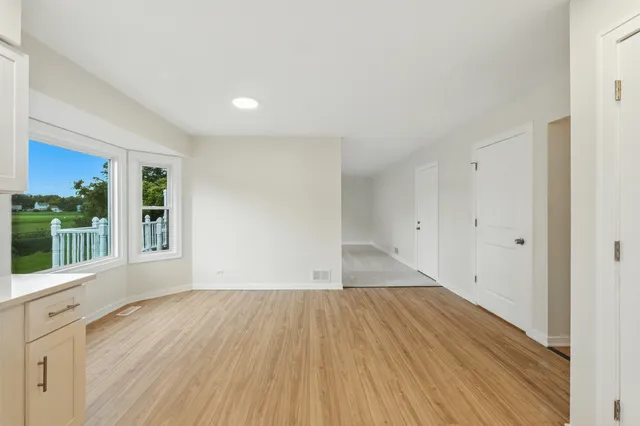 an empty room with fireplace and a window