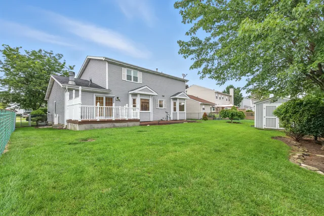an aerial view of residential houses with outdoor space and river