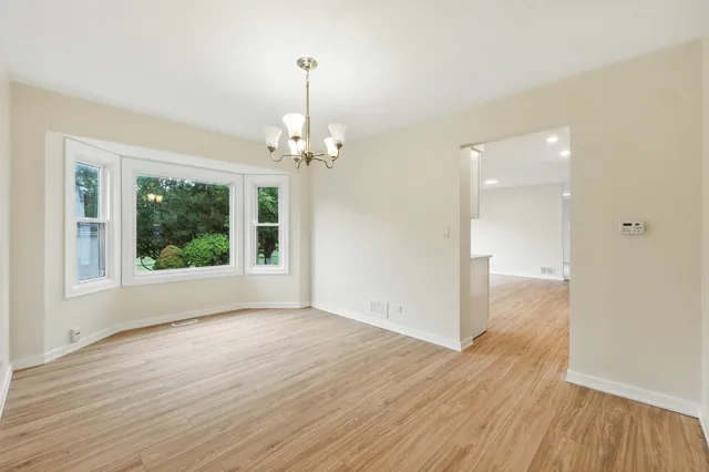 a large kitchen with a large counter top stainless steel appliances and a window