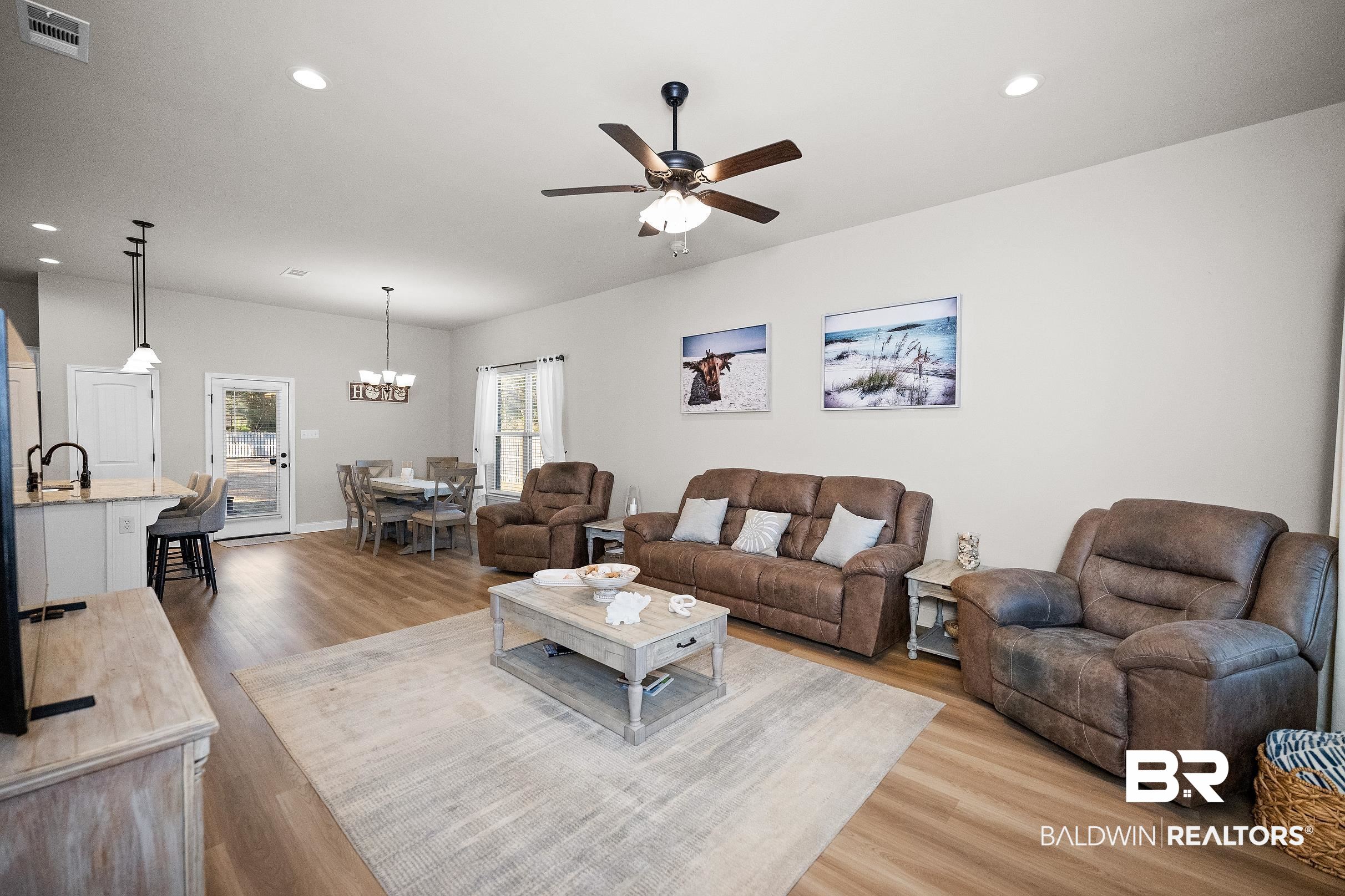 1077 Stella Road Foley, AL 36535 - Photo 4 of 27 Living room with a ceiling fan, wood finished floors, and a chandelier