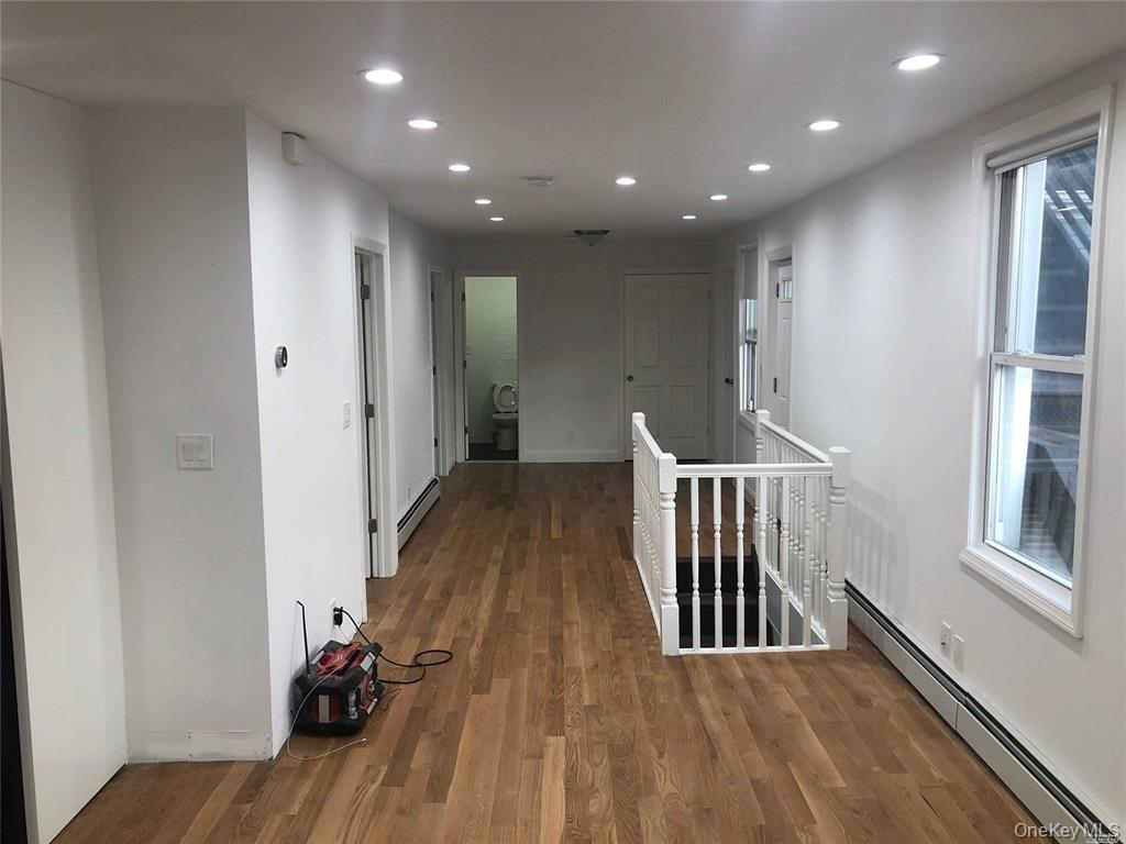 127-22 Hawtree Creek Road Queens, NY 11420 - Photo 2 of 12 a view of hallway with wooden floor
