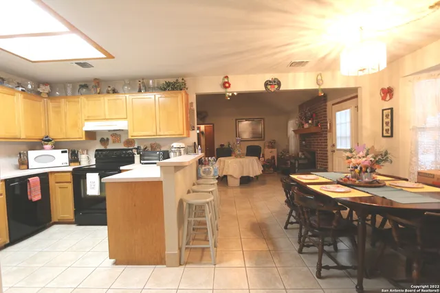 a en suite bathroom with a granite countertop sink and a mirror