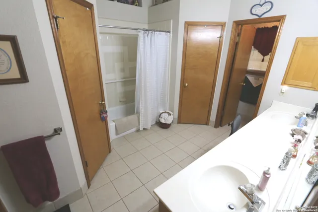 a view of a patio with a table and chairs under an umbrella