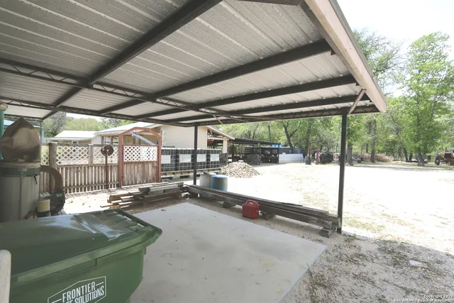a living room with hardwood floor and a floor to ceiling window