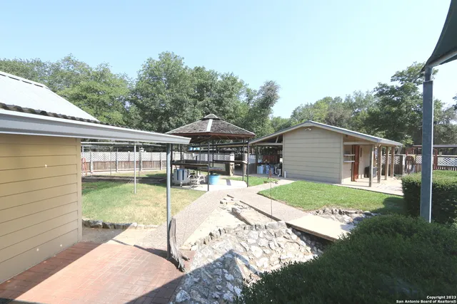 a view of a yard with a large tree