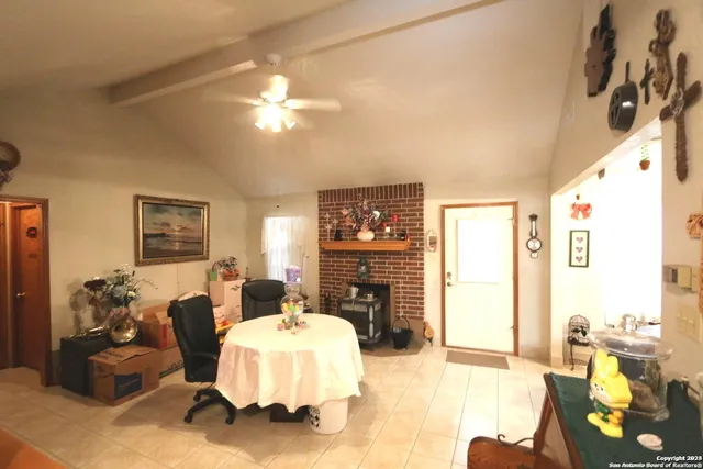 a kitchen with a refrigerator a sink dishwasher with a dining table and chairs