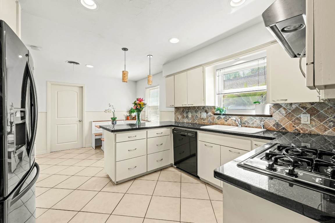 5827 Rutherglenn Drive Houston, TX 77096 - Photo 14 of 30 a kitchen with stainless steel appliances a stove a sink and a refrigerator