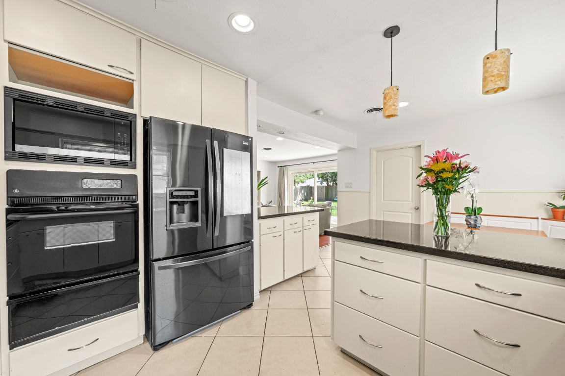 5827 Rutherglenn Drive Houston, TX 77096 - Photo 15 of 30 a kitchen with granite countertop stainless steel appliances and counter space