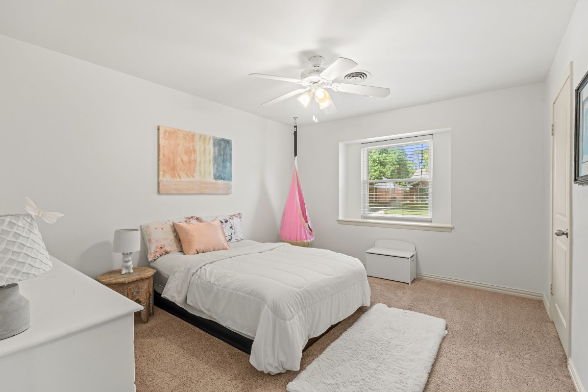 5827 Rutherglenn Drive Houston, TX 77096 - Photo 16 of 30 a bedroom with a bed and a chandelier